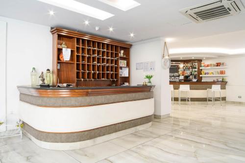 a bar in a room with a counter at Hotel La Mela in Varcaturo