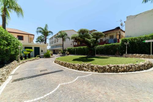 a tree in the middle of a driveway at Hotel La Mela in Varcaturo