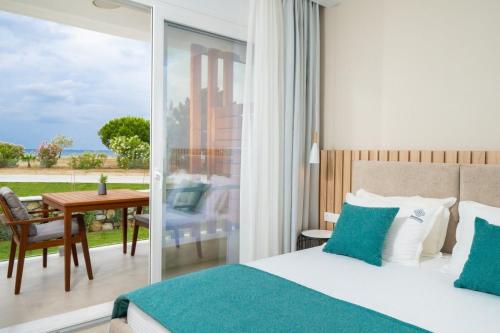 a bedroom with a bed and a view of the ocean at Sentimento Sea Breeze in Skala Prinou