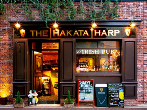 a store front of a haka harp with people sitting outside at Hotel Eclair Hakata in Fukuoka