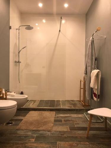 a bathroom with a shower and a toilet and a sink at Villa Pintucci in Trani