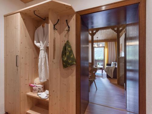 a wooden room with a dress hanging on a wall at Aparthotel Gallahaus in Zell am Ziller