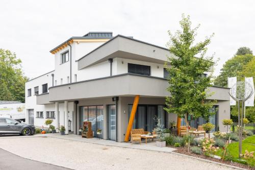 a white building with a car parked in front of it at Haidinger's Boutique Domizil in Oftering
