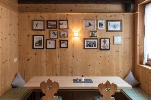 a room with a wooden wall with pictures on it at ArlBerglife Ferienresort in Pettneu am Arlberg