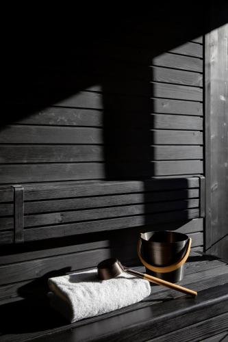 a bowl and a towel on a wooden table at HOTEL de LEN in Cortina dʼAmpezzo