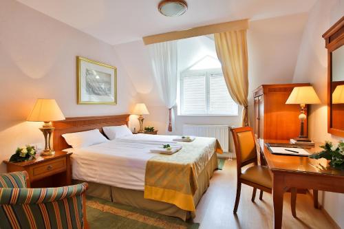 Postel nebo postele na pokoji v ubytování Hotel Rittinger