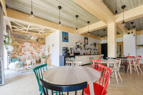 a dining room with tables and colorful chairs at Panocek i Babka in Białka Tatrzanska