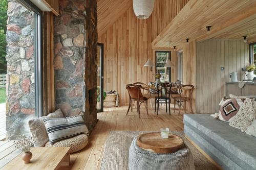 a living room with a couch and a table at domki w lesie Gdańsk 35 km in Bożepole Królewskie