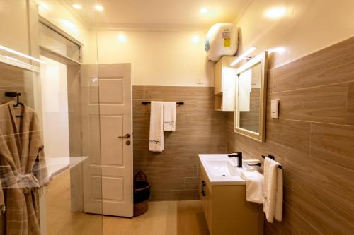 a bathroom with a sink and a mirror at MAYA Residences Rwanda in Kigali