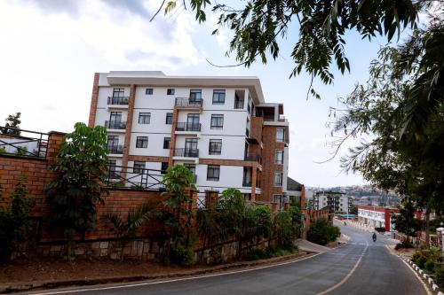 a tall white building on the side of a street at MAYA Residences Rwanda in Kigali