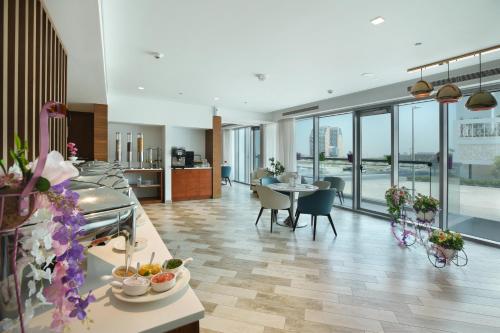 a large room with tables and chairs in a building at Millennium Executive Apartments Mont Rose in Dubai