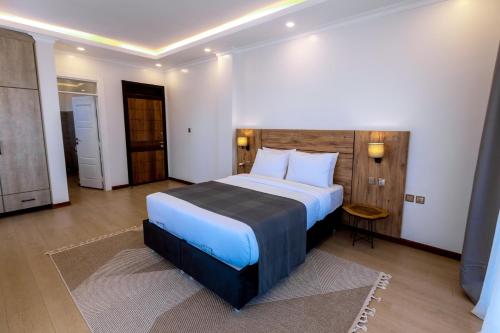 a bedroom with a large bed in a room at MAYA Residences Rwanda in Kigali