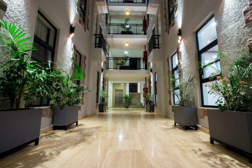 an empty hallway with potted plants in a building at MAYA Residences Rwanda in Kigali