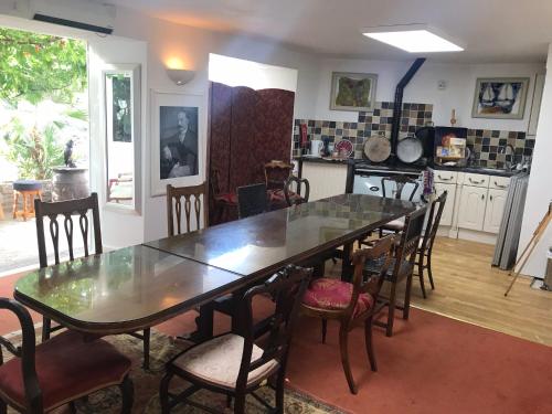 a dining room table and chairs in a kitchen at The Durbeyfield Guest House in West Bay