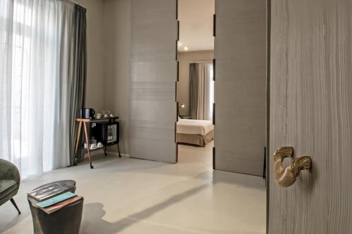 a room with a door leading to a bedroom at Atelier Inès Arts & Suites in Naples