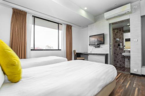 a hotel room with two beds and a television at Mahabir Palace in Kathmandu