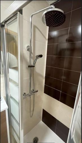 a shower with a glass door in a bathroom at Estudio en Ribeira in Ribeira