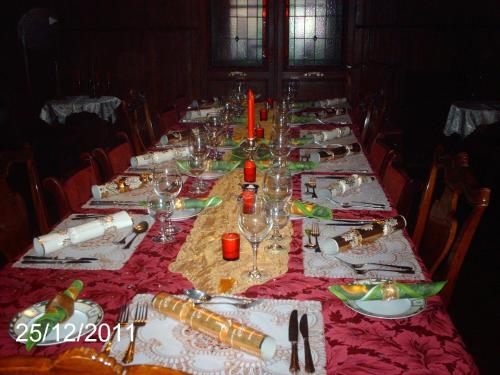 a long table with plates and wine glasses on it at Château Ardilleux in Ardilleux