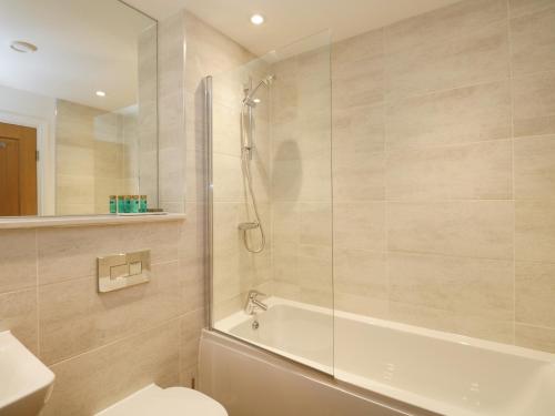 a bathroom with a shower and a toilet and a sink at The Florence Suite Stone Cross Mansion in Ulverston