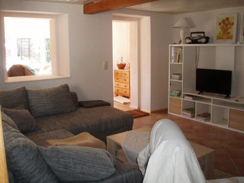 a living room with a couch and a tv at Ferienhaus Silvia 