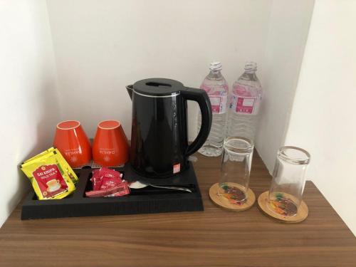 a coffee maker and two bottles of water on a table at Dahlia Boutique Hotel in Pokhara