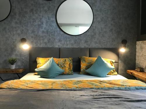 a bedroom with a bed with a mirror above it at Pod Papugą in Kościerzyna