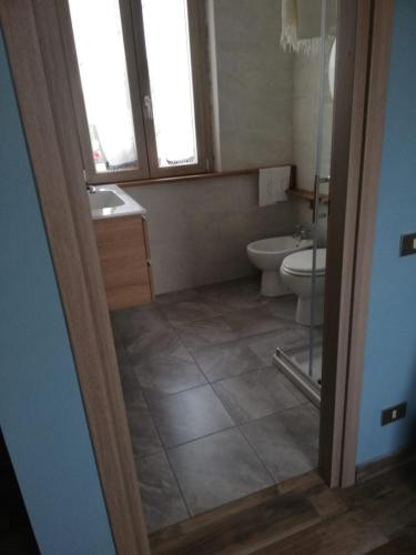 a bathroom with a toilet and a sink at Cascina Anita in Samarate