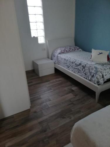 a bedroom with two beds and a wooden floor at Cascina Anita in Samarate