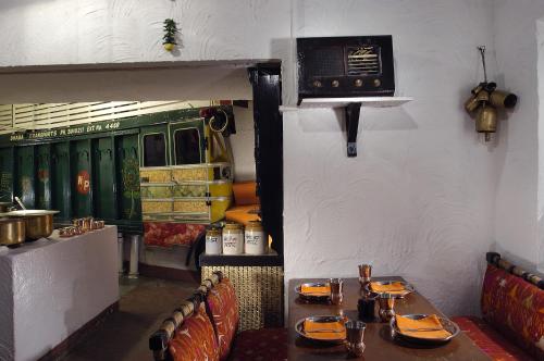 a restaurant with a table and chairs in a room at The Claridges New Delhi in New Delhi
