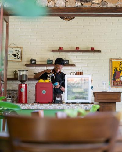 a man standing behind a counter in a kitchen at Bruga Villas Restaurant and Spa in Selong Belanak