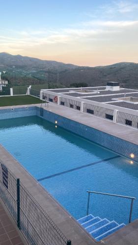 an overhead view of a large swimming pool at Charming apartment in Enix, Almería with shared pool in La Cañada de San Urbano