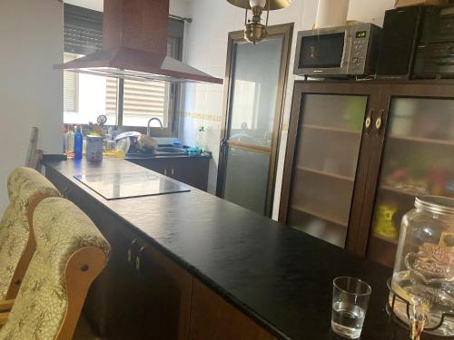 a kitchen with a black counter top in a kitchen at Charming apartment in Enix, Almería with shared pool in La Cañada de San Urbano