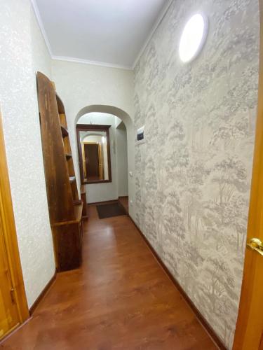 a hallway with a wall with a painting on it at Апартаменты аэропорт in Almaty