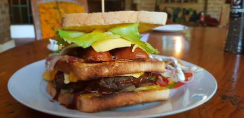 a sandwich on a white plate on a table at Barefoot Lodge and Safaris - Malawi in Lilongwe