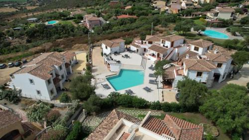 an aerial view of a house with a swimming pool at Residence Chiaro di Luna in San Teodoro