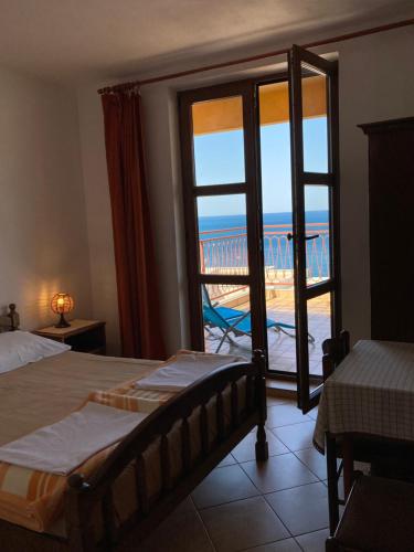a bedroom with a bed and a view of the ocean at Monterama Apartments in Sutomore