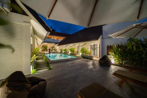 a swimming pool in the middle of a house at Bruga Villas Restaurant and Spa in Selong Belanak