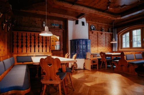 a dining room with a table and chairs at Alpenrose Bayrischzell Hotel in Bayrischzell