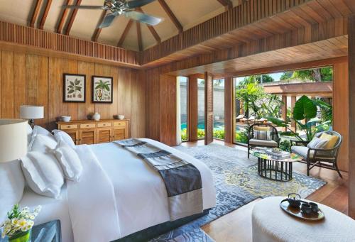 a bedroom with a large bed and a patio at Hotel Indigo Bali Seminyak Beach by IHG in Seminyak