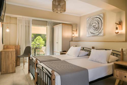 sypialnia z dużym łóżkiem i balkonem w obiekcie Irilena Hotel w mieście Lassi