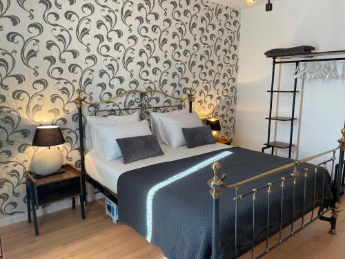 a bedroom with a bed with a damask wallpaper at Apartments CLIFF Piran in Piran