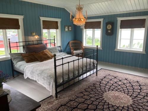 a bedroom with a bed and a chandelier at Steinsvoll Gård in Vang I Valdres