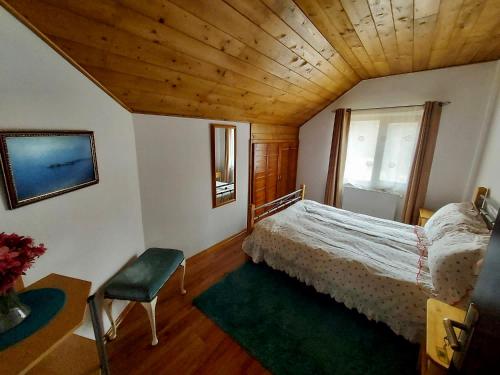 a bedroom with a bed and a wooden ceiling at Cabana Sweetlife in Rimetea