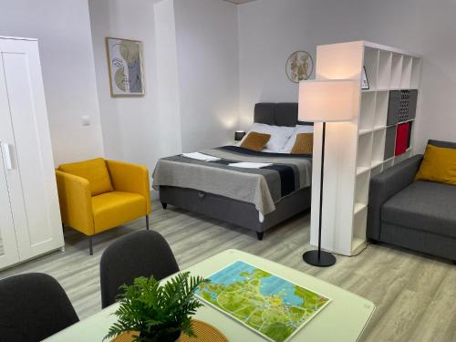 a bedroom with a bed and a chair and a table at Apartment Studio Beauty in Centar in Pula