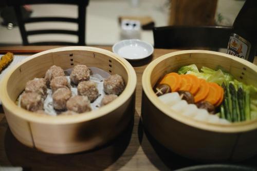 two bowls of food with meatballs and vegetables on a table at RONENAI BASE in Biei