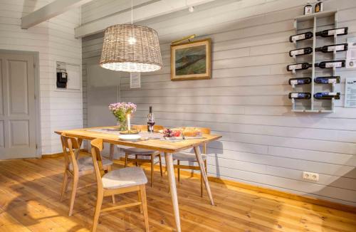 a dining room with a wooden table and chairs at traumHaff - Sea Hideaway Ostsee Region - privates NORDICSPA, Kamin, Kunst, Hund 300m zum Strand in Rieth