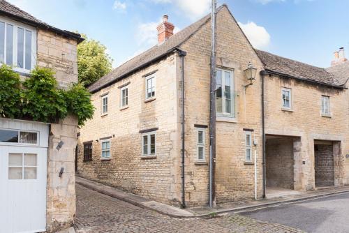 an old brick building on the side of a street at Luxury cottage in Stamford featured in the Sunday Times, best place to live in Stamford