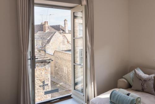 a room with a large window with a view at Luxury cottage in Stamford featured in the Sunday Times, best place to live in Stamford