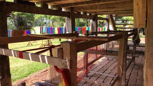 a wooden structure with a fence with colorful flags at On The Mekong Resort in Luang Prabang