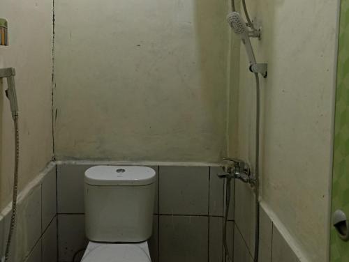 a small bathroom with a toilet and a shower at Hoya Residence Syariah in Sodong